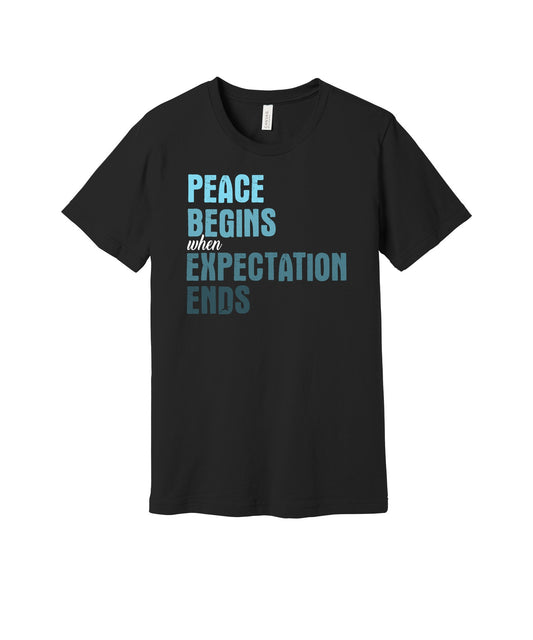 Peace Begins Where Expectations End graphic on a black Bella+Canvas 3001 tee