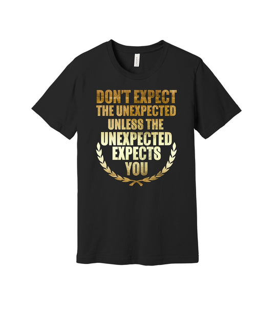 Don't Expect the Unexpected graphic on a black Bella+Canvas 3001 tee