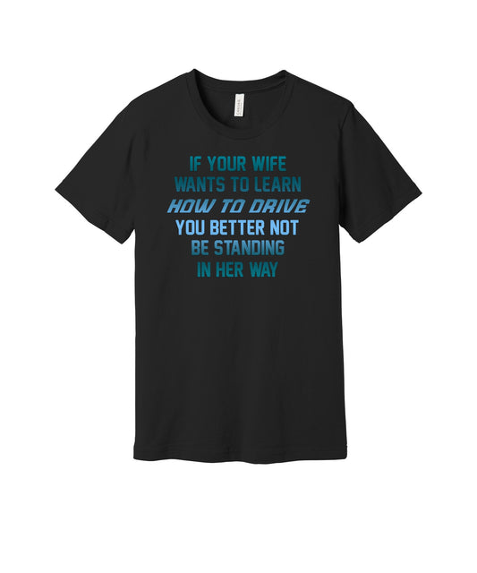 When Your Wife Learns to Drive graphic on a black Bella+Canvas 3001 tee