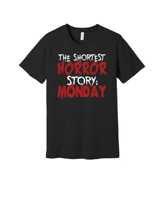 Shortest Horror Story Monday graphic on a black Bella+Canvas 3001 tee
