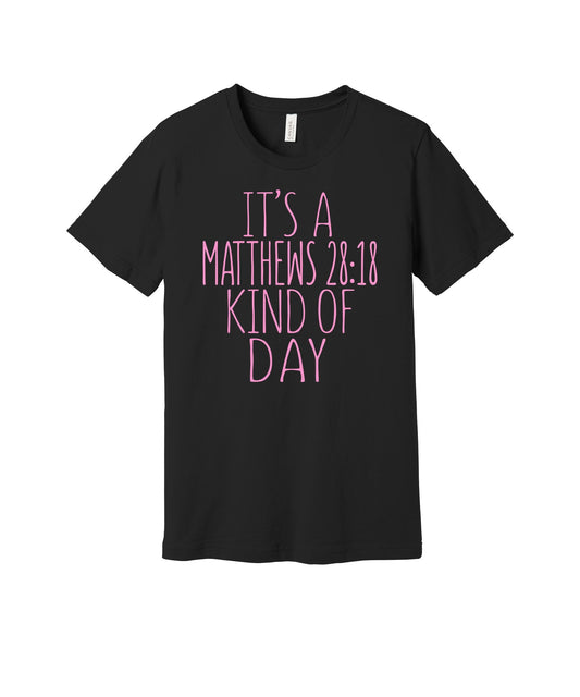 Matthew 28:18 Kind of Day graphic on a black Bella+Canvas 3001 tee