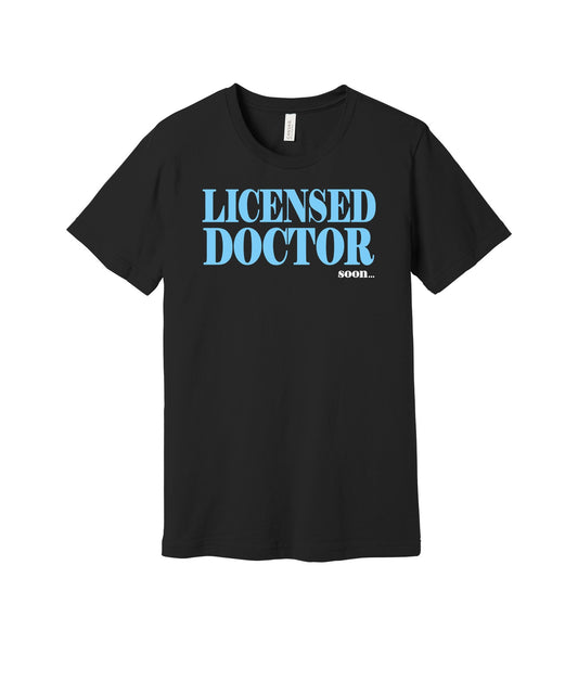 Licensed Doctor Soon graphic on a black Bella+Canvas 3001 tee