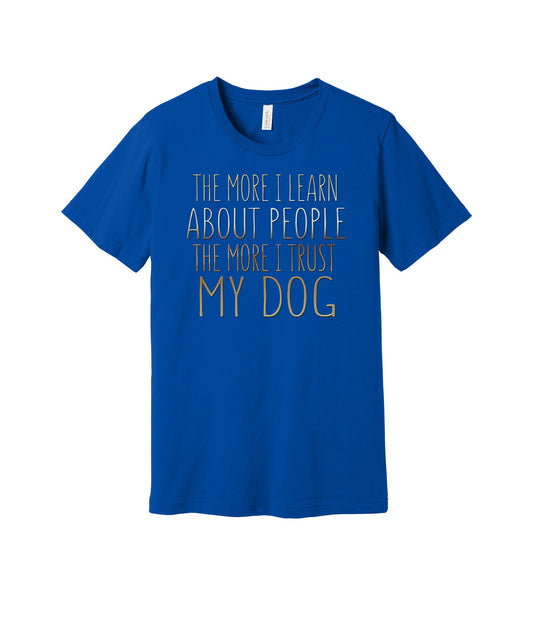 The More I Trust My Dog graphic on a true royal Bella+Canvas 3001 tee