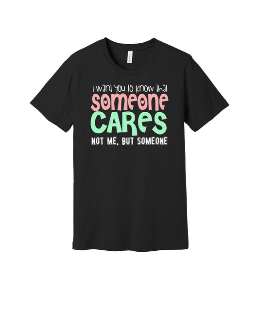 Someone Cares graphic on a black Bella+Canvas 3001 tee